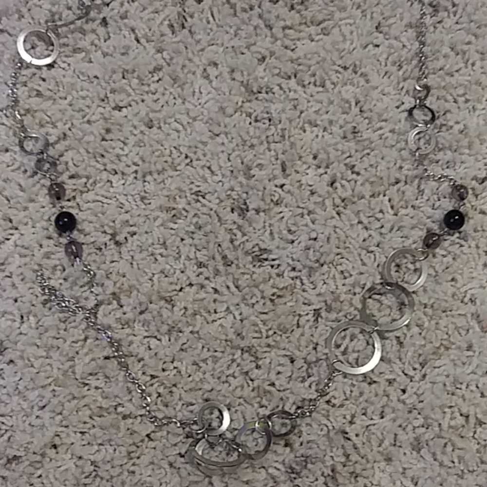 A silver and black beaded necklace w/ earrings